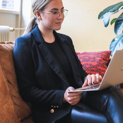 woman in black blazer using macbook